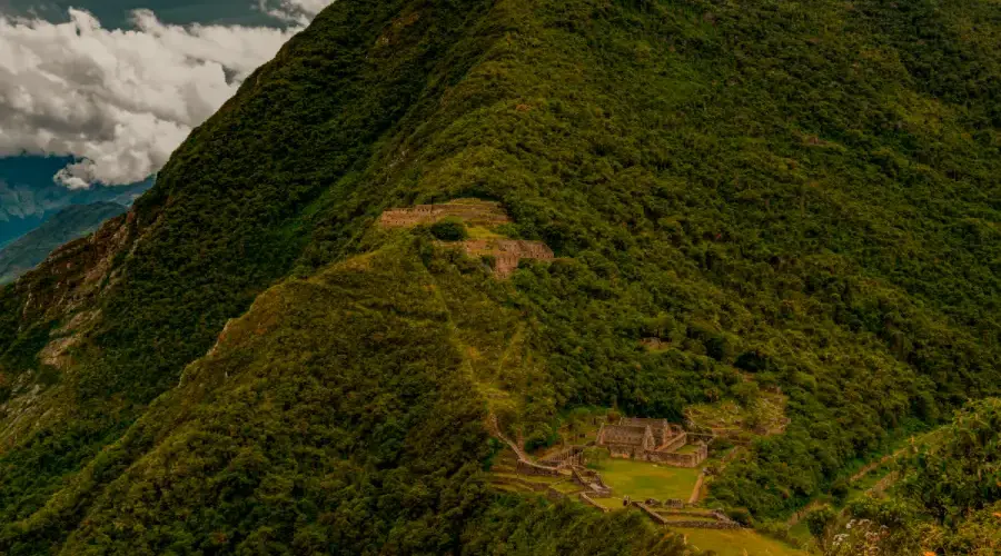 Choquequirao ruins surrounded by green mountains in the Andes