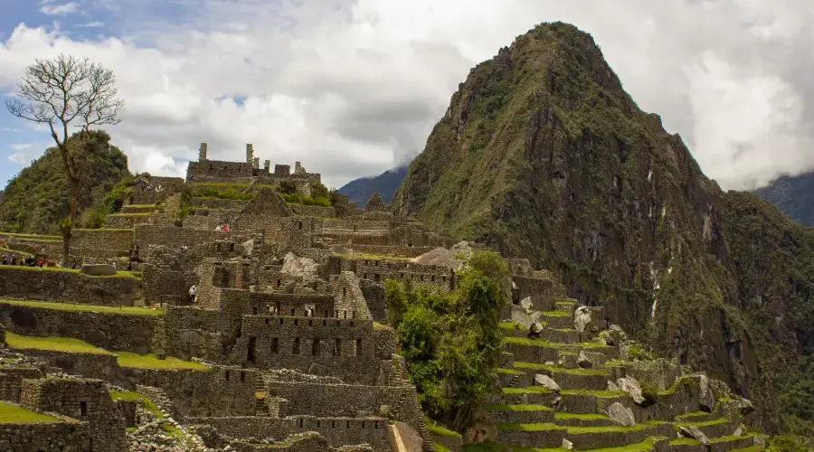 Panoramic view of Machu Picchu surrounded by mountains and clouds