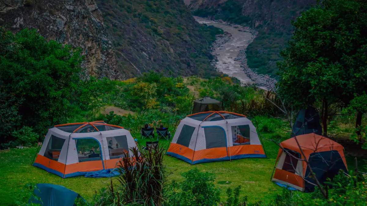 mountain camp valley view expedition camp set in a green valley beside a mountain river in the Andes