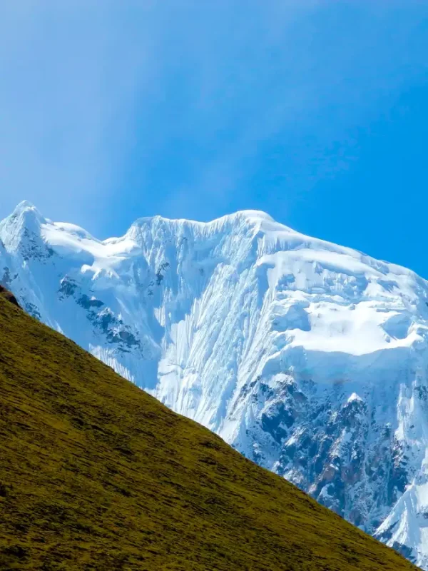 Green Andean mountains and snowy peaks along the Salkantay Luxury Glamping Trek 5 Days