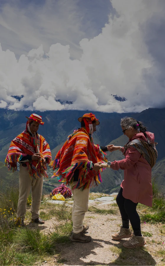 Cultural experience with local communities in Cusco, Peru Travelers interacting with local Andean people in traditional clothing in the mountains of Cusco, Peru