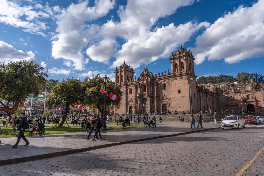 cusco main square before trek Travelers exploring Cusco's historic center before beginning a multi-day trek in the Andes