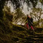 How to Prepare for the Inca Trail: Beginner Training Guide Traveler demonstrating how to prepare for the Inca Trail by hiking uphill with a backpack in the Peruvian Andes