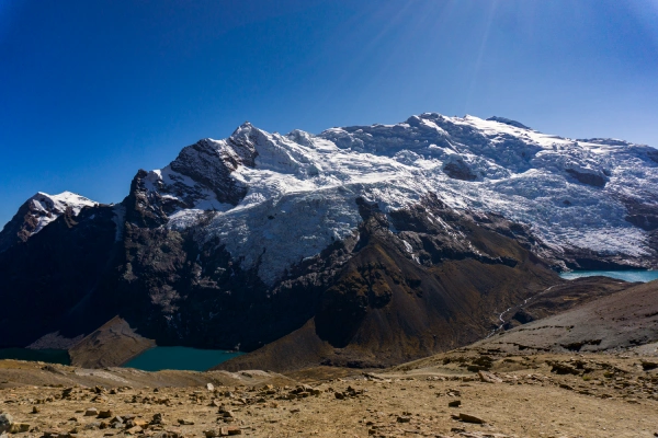 Turquoise glacial lakes surrounded by rugged snow-covered mountains in the Andes