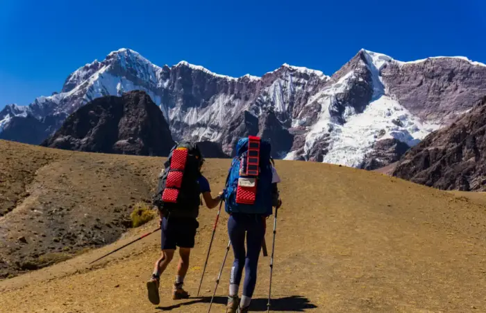 Hikers on the Ausangate Luxury Glamping Trek surrounded by the snow-capped Andes