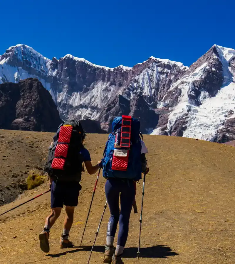Hikers on the Ausangate Luxury Glamping Trek surrounded by the snow-capped Andes
