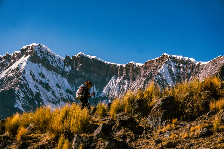 Hiker walking through the rugged high-Andean landscape of Ausangate in Peru