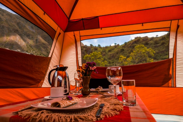 Dining Experience at Luxury Camp Dining table prepared inside a luxury camping tent
