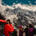 High-Altitude Trekking in Peru Hikers enjoying high altitude trekking in Peru among the snow-capped Andes