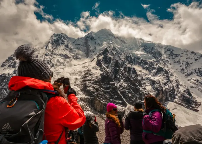 Hikers enjoying high altitude trekking in Peru among the snow-capped Andes
