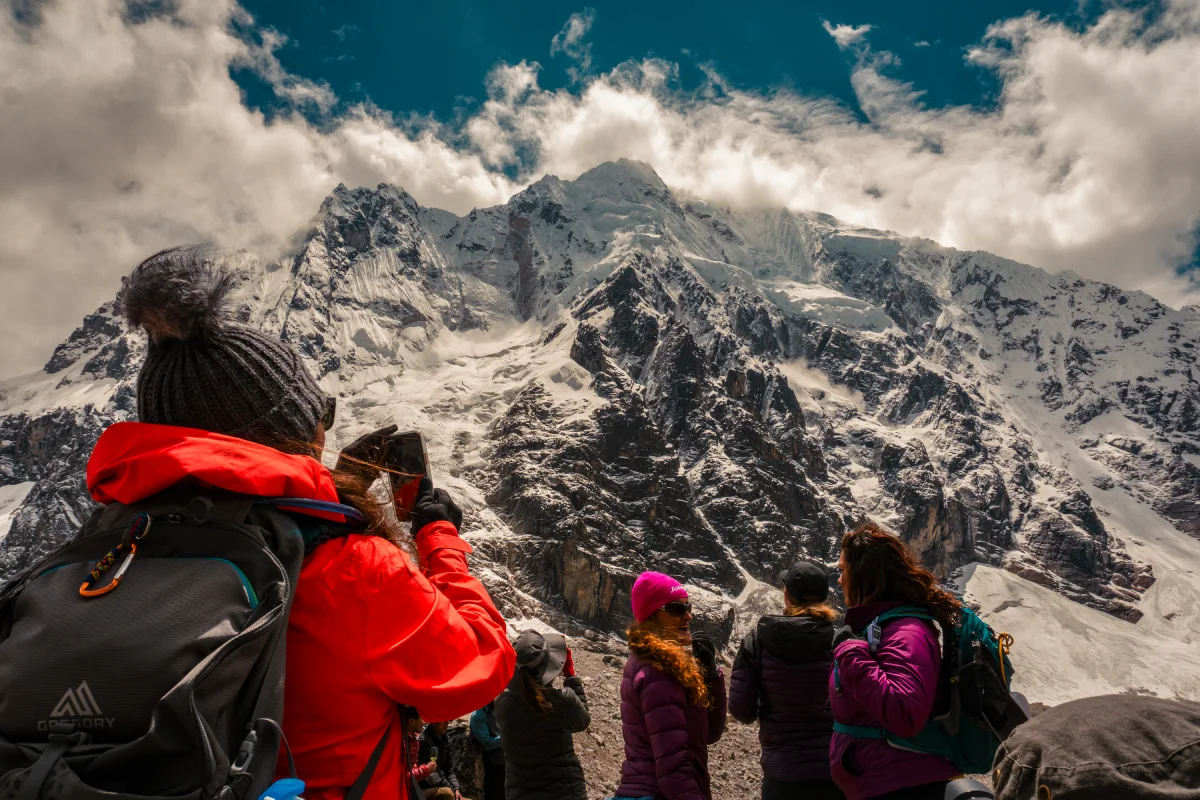 Hikers enjoying high altitude trekking in Peru among the snow-capped Andes