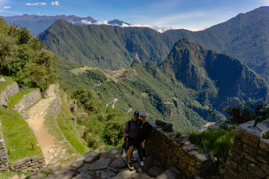 A Journey Through the Andes Travelers standing on the ancient Inca Trail surrounded by lush Andean mountains