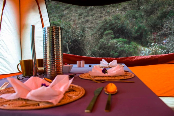 Dining Experience in the Andes Prepared dining table inside a glamping tent overlooking the Andes