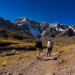 What to Pack for the Ausangate Trek: hikers carrying essential gear through the Peruvian Andes