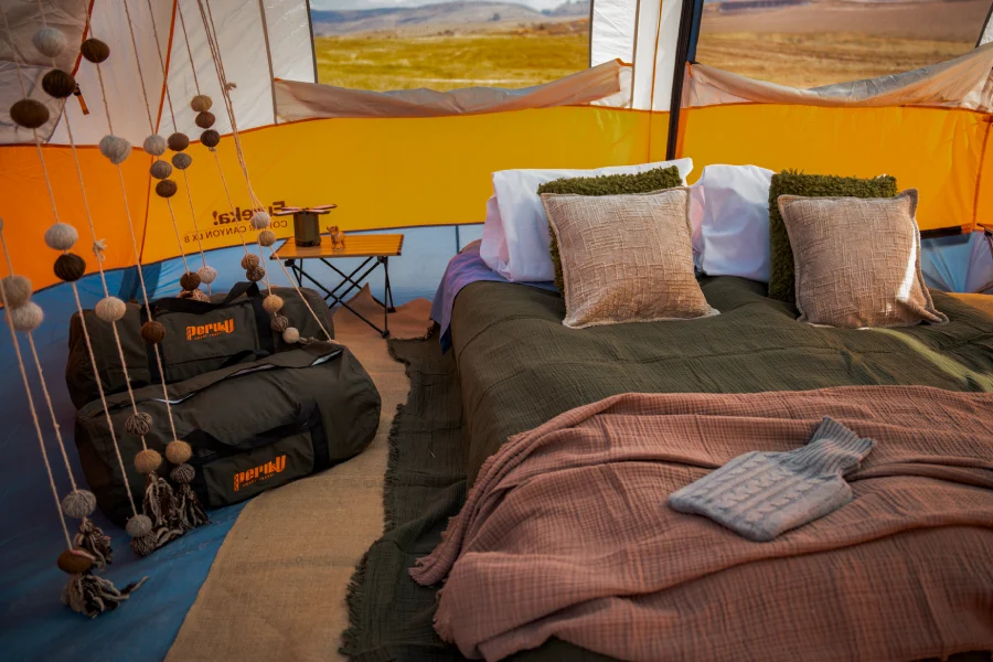 Comfortable Bed Inside a Mountain Tent Comfortable bed inside a spacious mountain glamping tent