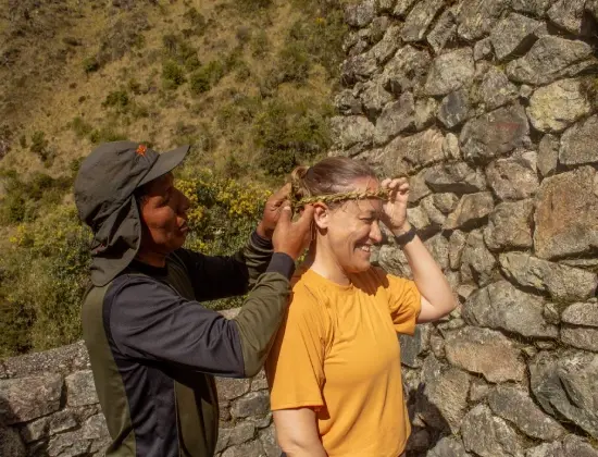 Local guide placing a traditional floral headband on a smiling traveler.